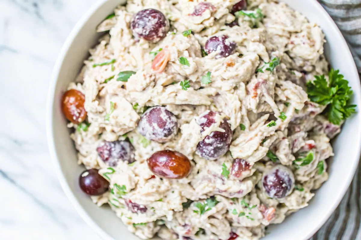 Top-down view of Chicken Salad with Grapes and Pecans in a white bowl
