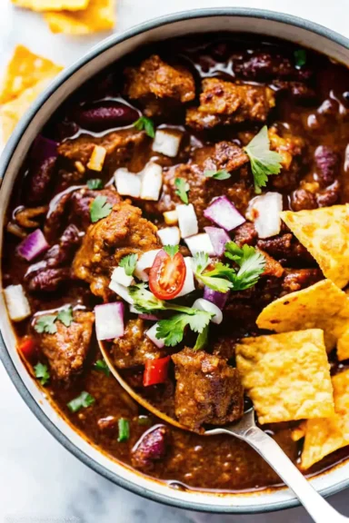 Steak chili served with fresh onions and cilantro.